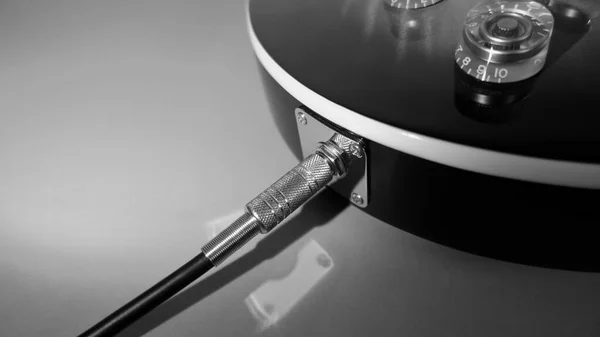 stock image electric guitar and cable closeup . black and white