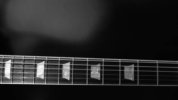 Electric guitar neck closeup . black and white