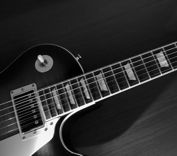 Electric guitar closeup . Dark background .