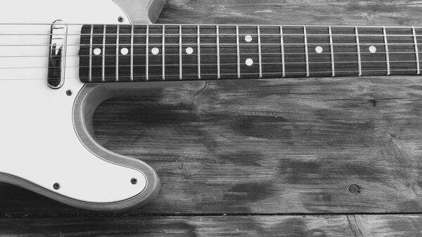 Vintage electric guitar closeup on the wooden boards