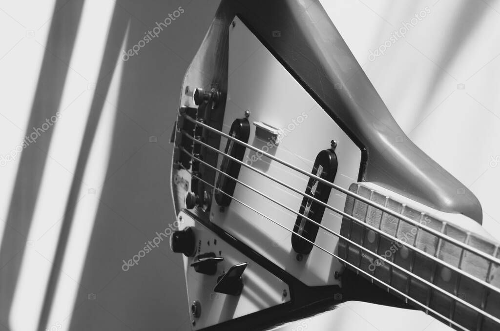 Old vintage bass guitar with copy space . light and shadow. black and white