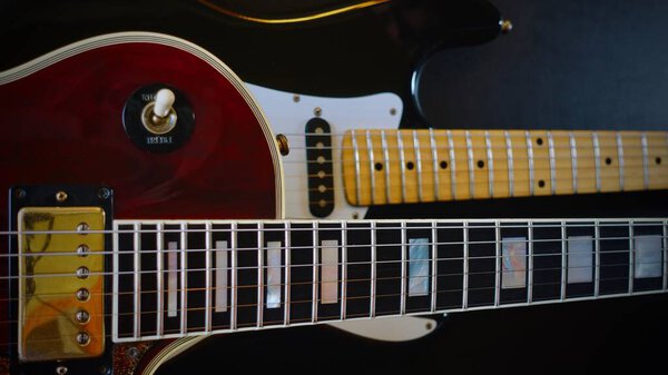 Two vintage electro guitars closeup . dark background