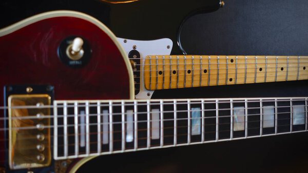 Two vintage electro guitars closeup . dark background