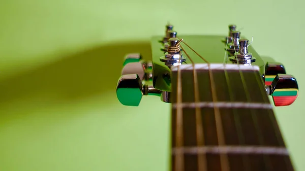 guitar headstock closeup . green background  . copy space