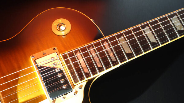 Vintage guitar closeup . Color background . Copy space
