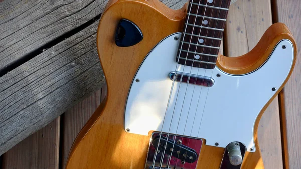 guitar on the wooden boards