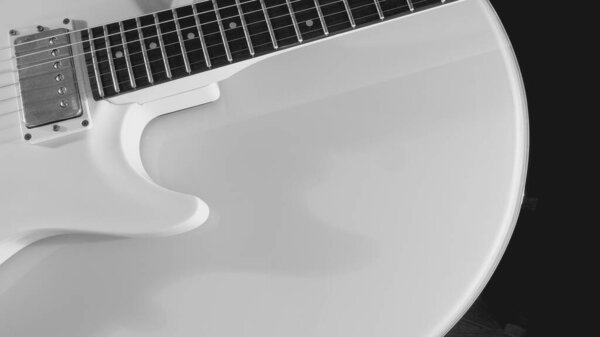 White electric guitar closeup . White background with copy space . black and white