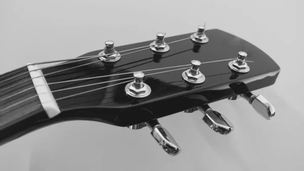 black guitar neck and headstock with copy space . black and white