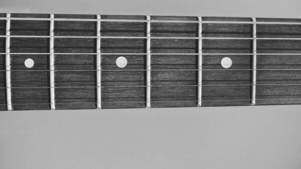 Electric guitar neck closeup with copy space . black and white