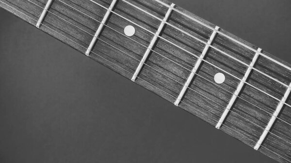 Electric guitar neck closeup with copy space . black and white
