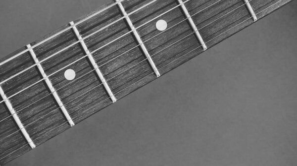 Electric guitar neck closeup with copy space . black and white
