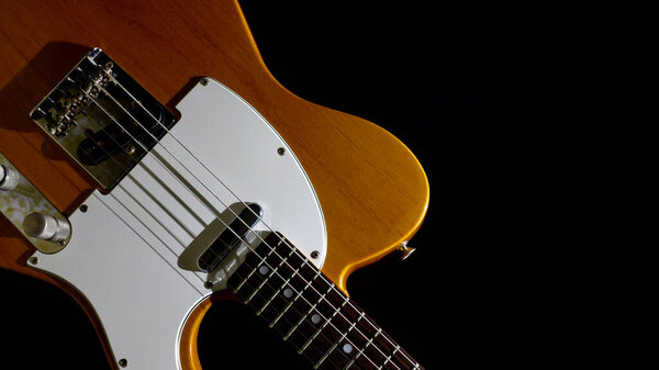 Vintage electric guitar closeup . Copy space . Dark background