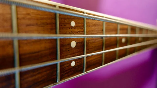 Bass Guitar Neck Copy Space Purple Background — Stock Photo, Image