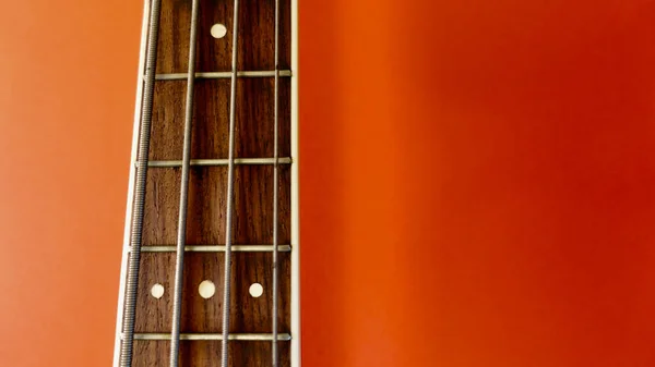 Bass Guitar Neck Closeup Copy Space Red Background — Stock Photo, Image