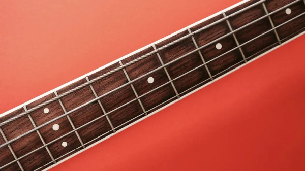 Bass Guitar Neck Closeup Copy Space Red Background — Stock Photo, Image