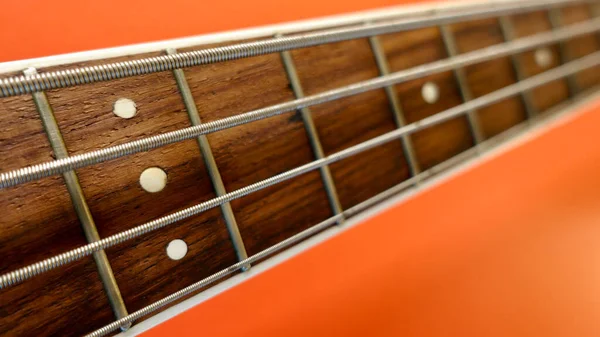 Bass Guitar Neck Closeup Copy Space Orange Background — Stock Photo, Image