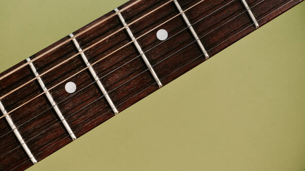 Guitar headstock closeup . Green background