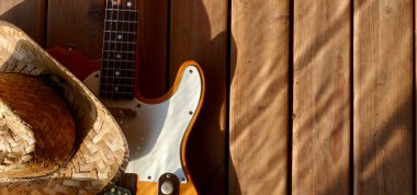 Tahtada klasik elektro gitar ve kovboy şapkası..