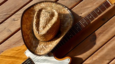 Tahtada klasik elektro gitar ve kovboy şapkası..