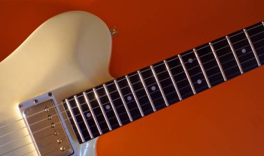 Beyaz gitar yakın plan. kopyalama alanı olan renk arkaplanı