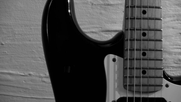 Electric guitar closeup . Background with copy space . Black and white