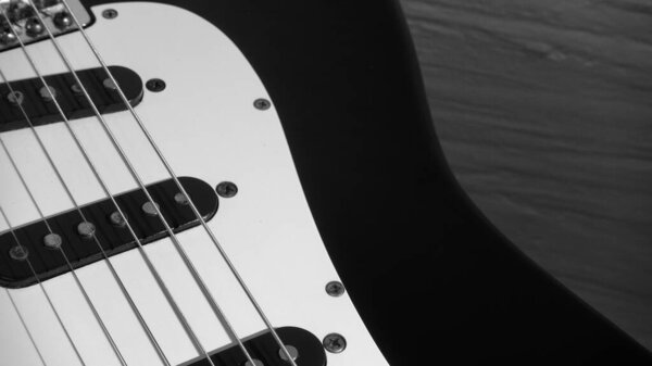 Electric guitar closeup . White wall background with copy space