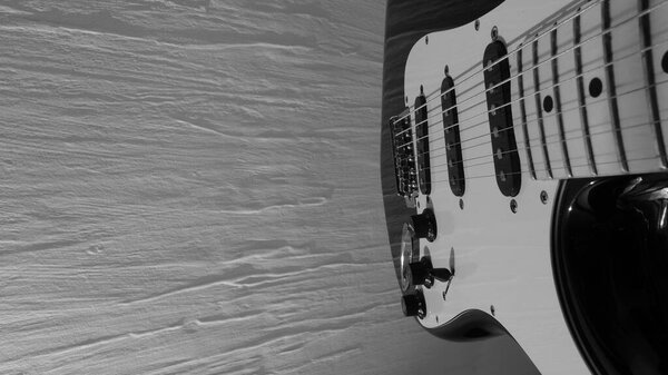 Electric guitar closeup . White wall background with copy space