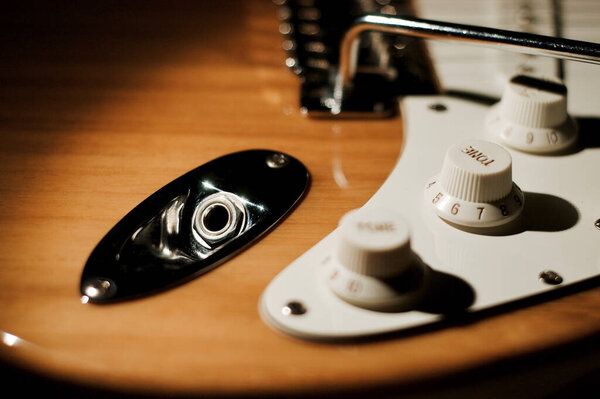 Electric guitar closeup . Dark background