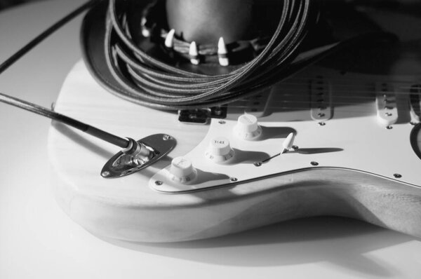 Electric guitar and black cowboy hat . Black and white