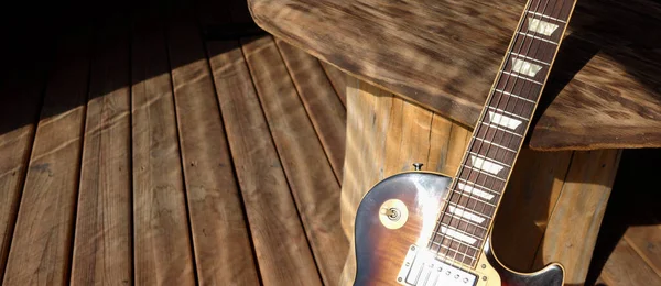 Vintage electric guitar  on the wooden boards