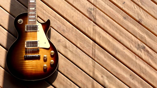 vintage electric guitar on the wooden boards