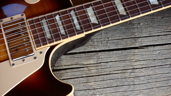 Vintage electric guitar on the wooden boards