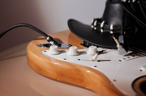 Electric guitar closeup and black cowboy hat