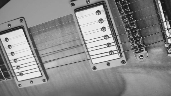 Vintage electric guitar closeup . Copy space . black and white