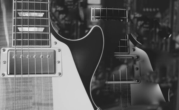 Vintage electric guitar closeup . Copy space . black and white