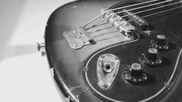 Old bass guitar closeup . black and white