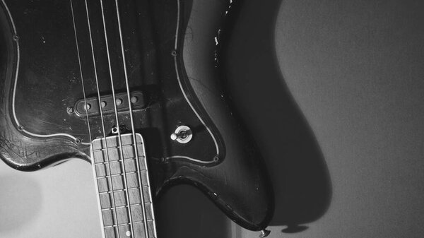 Old bass guitar closeup . black and white