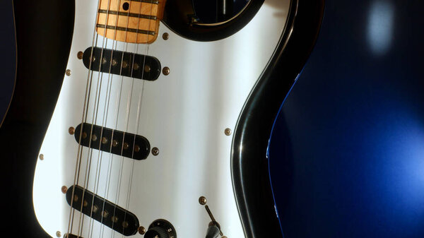 Electric guitar closeup . Color background