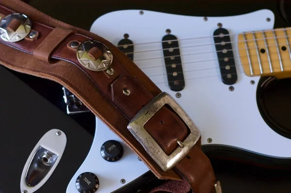 Electric guitar closeup and guitar strap .