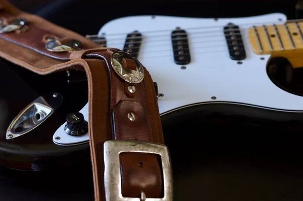 Electric guitar closeup and guitar strap .