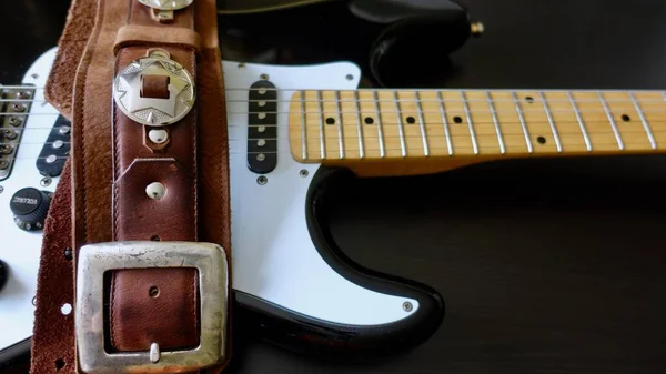 Electric guitar closeup and guitar strap .