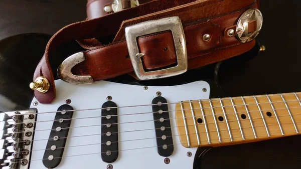 Electric guitar closeup and guitar strap .