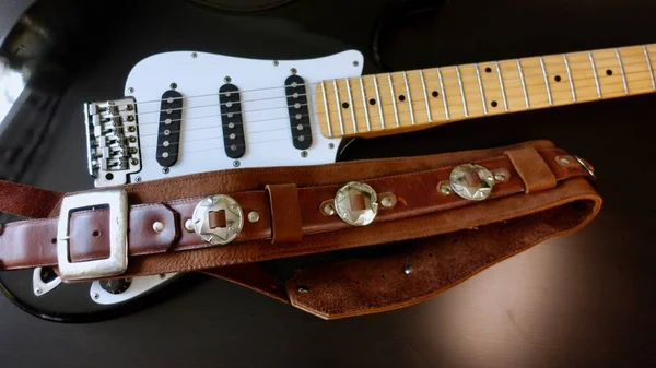 Electric guitar closeup and guitar strap .