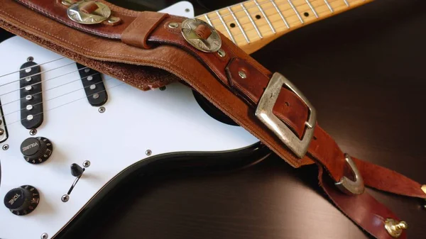 Electric guitar closeup and guitar strap .