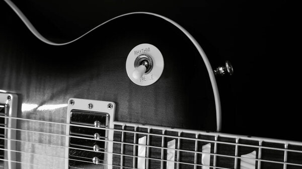 Electric guitar closeup . Dark background