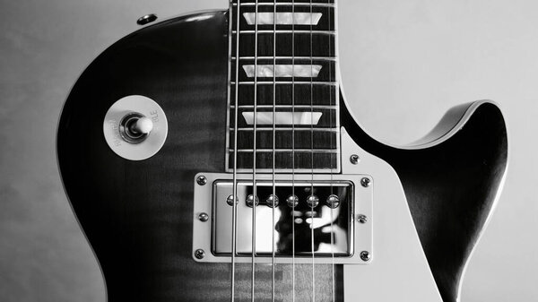 Two Electric guitars closeup dark background with copy space . Black and white