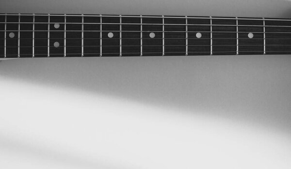 Vintage electric guitar closeup . Copy space . Black and white