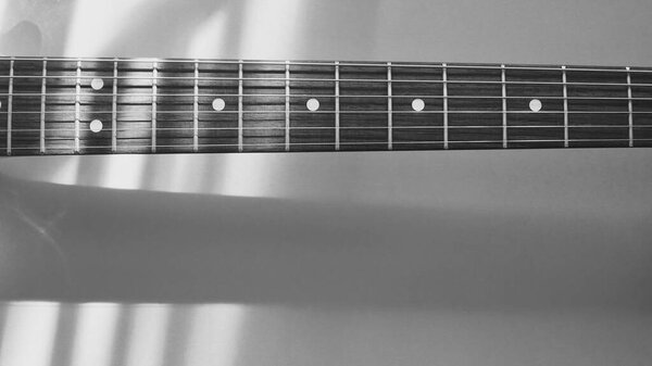 Vintage electric guitar closeup . Light and shadow Copy space . Black and white