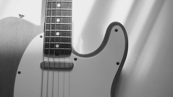 Vintage electric guitar closeup . Copy space . Black and white