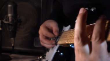 Gitarist stüdyoda elektro gitar çalıyor. Yavaş çekim 100p